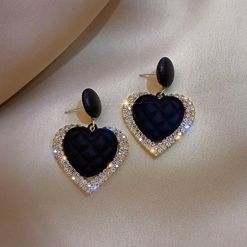 Black heart-shaped gold earrings