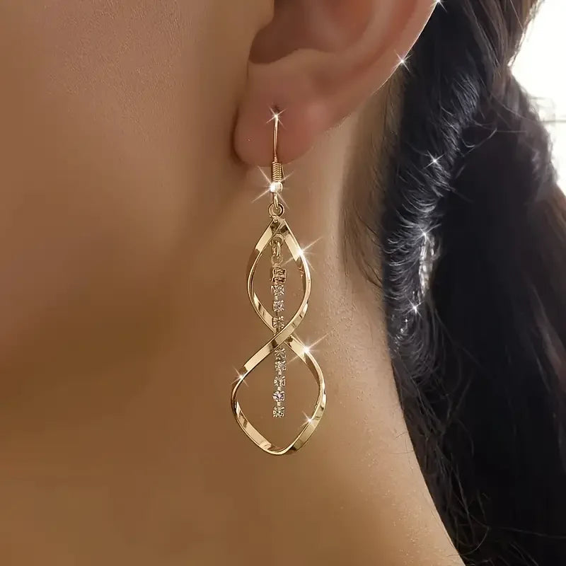 Earrings in the shape of a sunbeam spiral | Gold