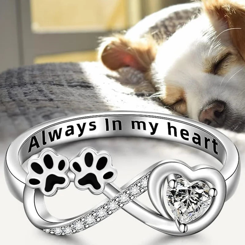 Ring with paw-shaped zirconia stones, heart and infinity symbol.